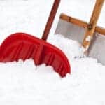 Two shovels for snow removal in fresh snow